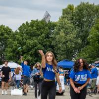 Student throws beanbag during game of cornhole during tailgate.
